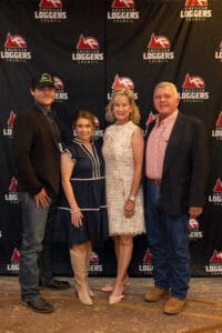 Four people posing at Loggers Council event.