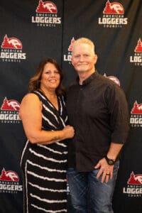 Couple posing at American Loggers event.