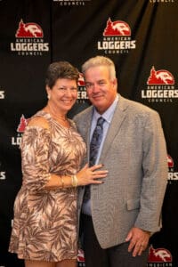 Smiling couple at American Loggers Council backdrop