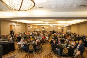 People wearing masks at a conference event.