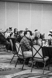 Attendees seated at conference round tables