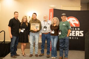 Group standing at an award event.