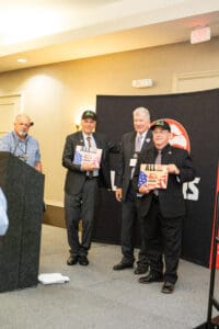 Four men at an awards presentation event.