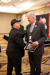 Two men shaking hands at conference event