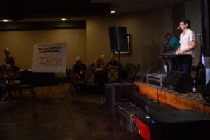 Musician performing at indoor venue event.