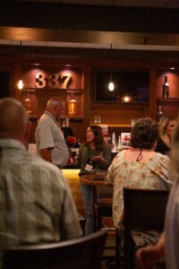People talking in a dimly lit bar.