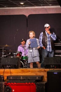 People on stage with musical instruments.