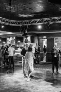 Couple dancing in a dimly lit venue.