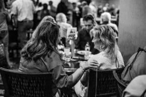 People talking at a crowded restaurant table.