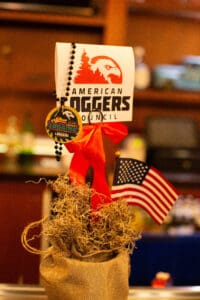 American Loggers Council sign with flag decoration.