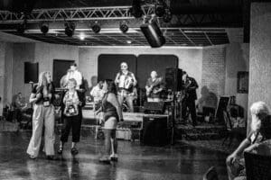 Black and white band performance with audience.