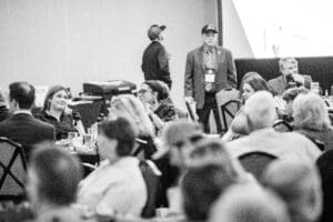 Conference attendees seated at round banquet tables