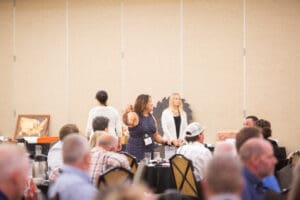 Conference attendees engaging in a discussion.