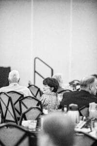Black and white people at a conference.