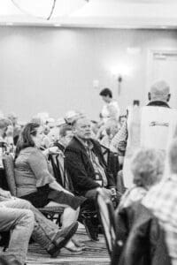 Seated conference attendees listening during a session