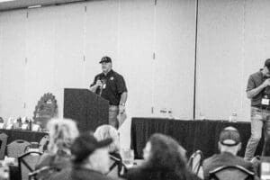 Man speaking at a podium during event.