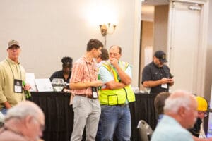Man in safety vest talking with colleague