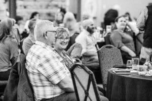Elderly couple smiling at an event.