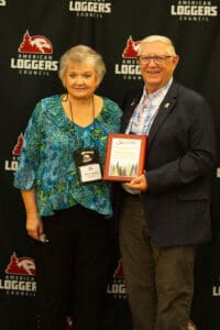 Two people with an award at event.