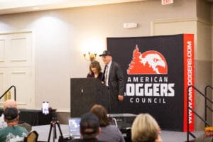 Speakers at American Loggers Council event podium.
