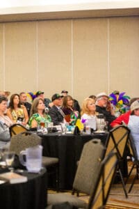 People seated at a formal event.