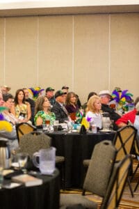 People attending a conference with colorful decorations.
