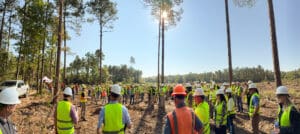 Construction workers gathering in a forest clearing.