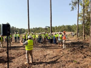 Group in safety gear at construction site.