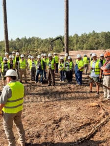 Group in safety vests at construction site.