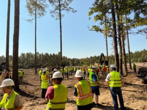 Construction workers gathering in a forested area.