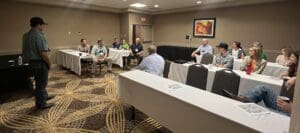 People attending a meeting in conference room.