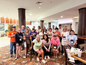 Cheerful group posing in hotel lobby