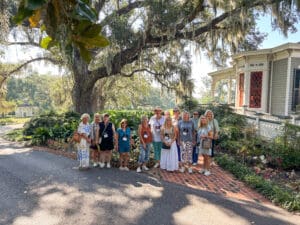 Group posing in front of large tree.