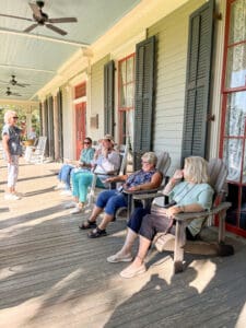 Women relaxing and chatting on shady porch