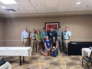 Nine colleagues posing in conference meeting room